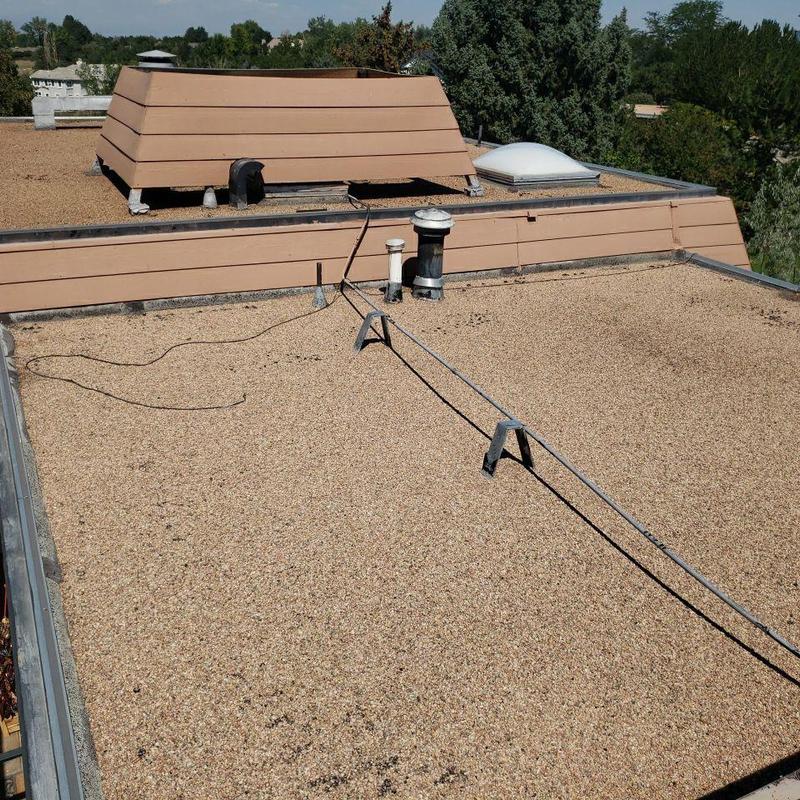 Tar and gravel flat roof with vents and pipes