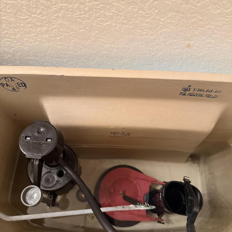 Toilet tank fill valve and flapper assembly inside tank