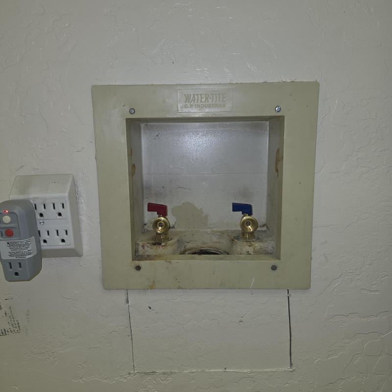 Washer valve box with red and blue valves