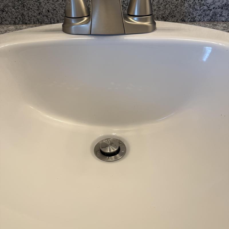 Bathroom faucet and pop-up drain assembly with sink