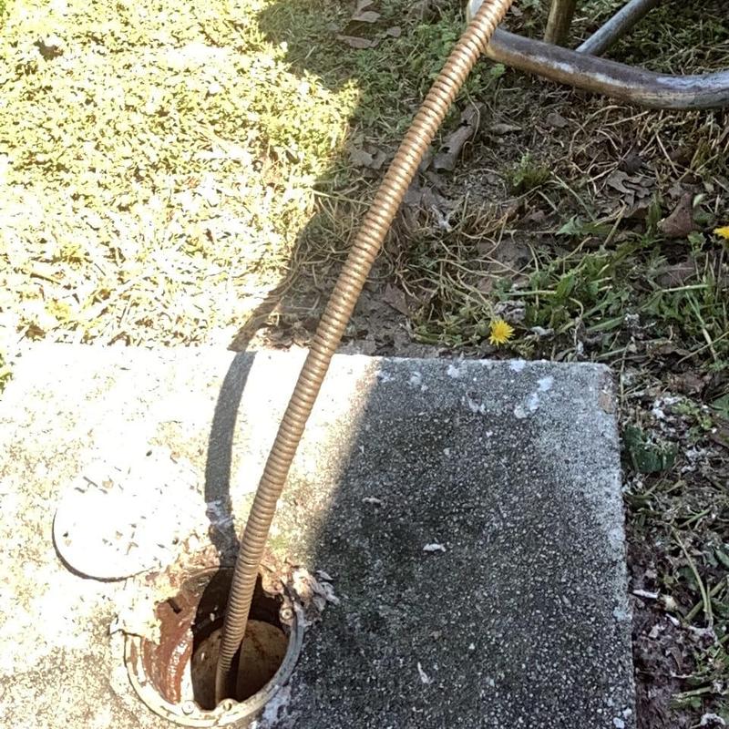 Cleanout pipe with drain snake in concrete slab