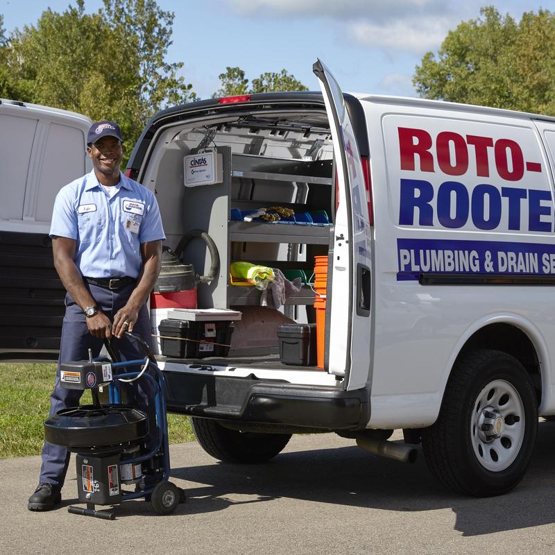 Drain cleaning machine with technician by service van