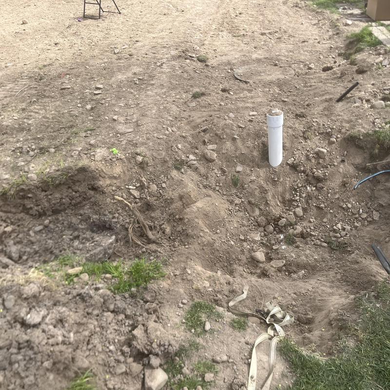 Septic tank pump-out site with exposed vent pipe