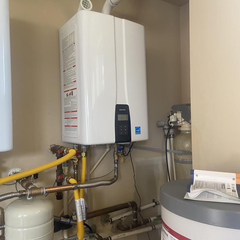 Tankless water heater installation with piping connections