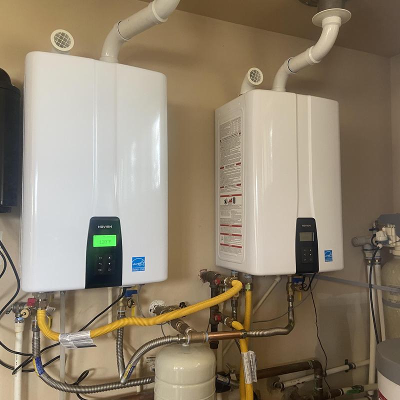 Tankless water heaters with piping and vent installation