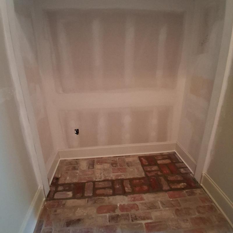 Brick flooring with baseboard and quarter round installed