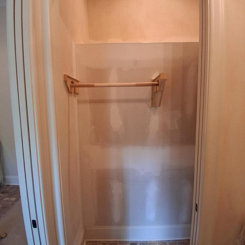 Custom closet clothes rod with wooden brackets