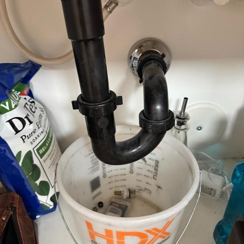 Bathroom sink P-trap cleaning with parts in bucket Bathroom sink P-trap cleaning with parts in bucket