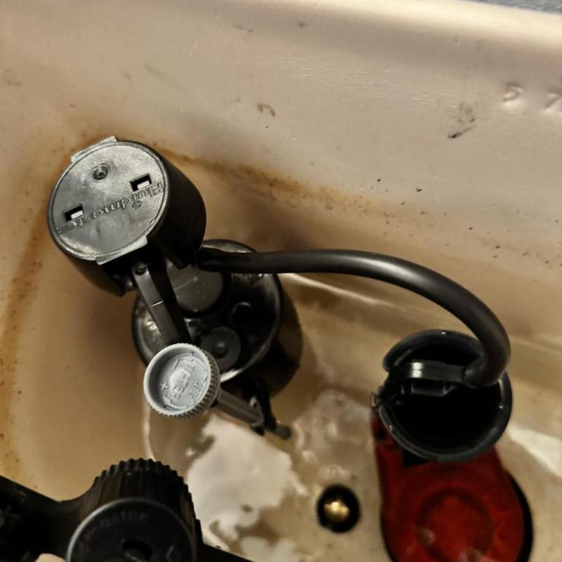 Toilet fill valve and flushing mechanism inside tank