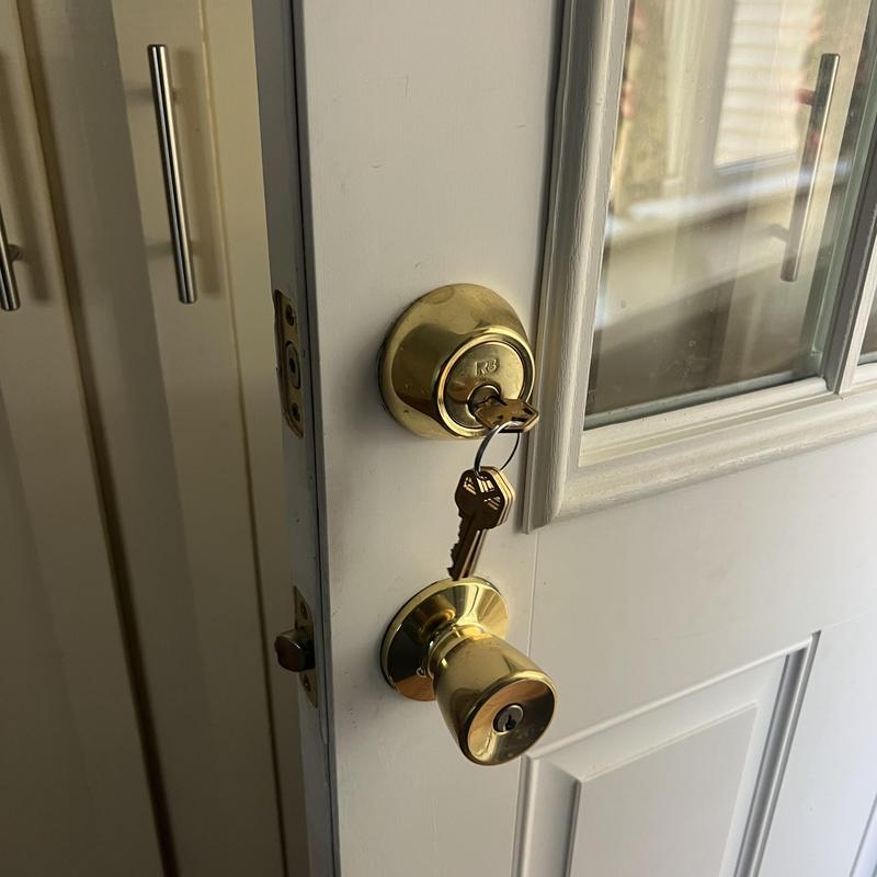 House door deadbolt lock with keys inserted