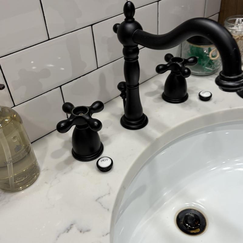 Black bathroom tub faucet and handles on marble counter Black bathroom tub faucet and handles on marble counter