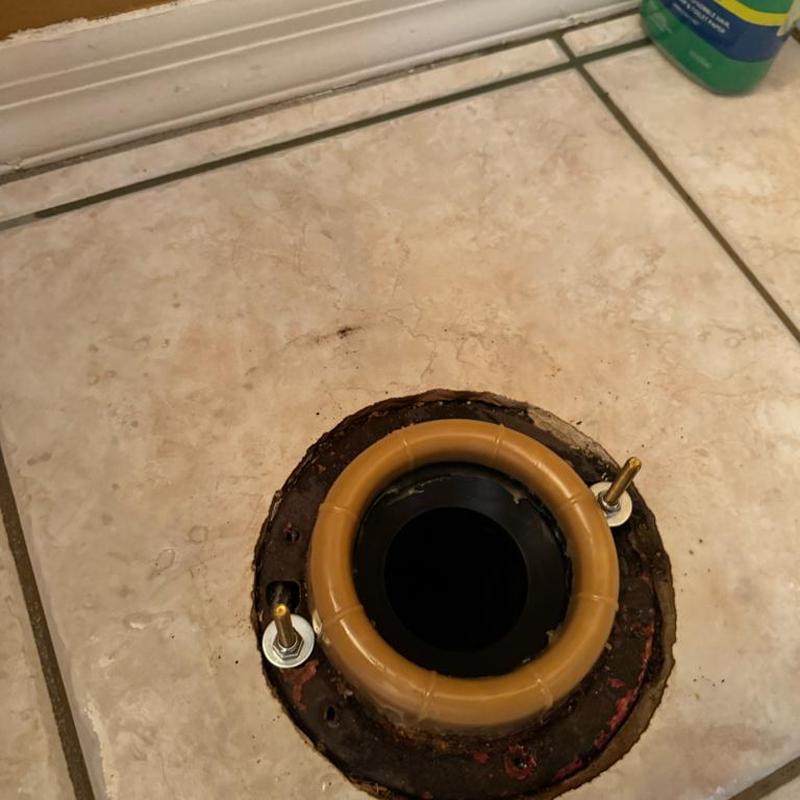 Toilet flange with new rubber wax ring and bolts installed