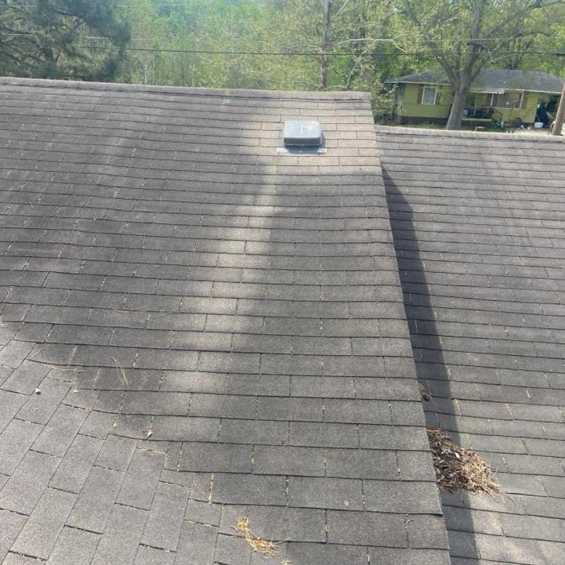 Asphalt shingle roof with vent, debris in valley