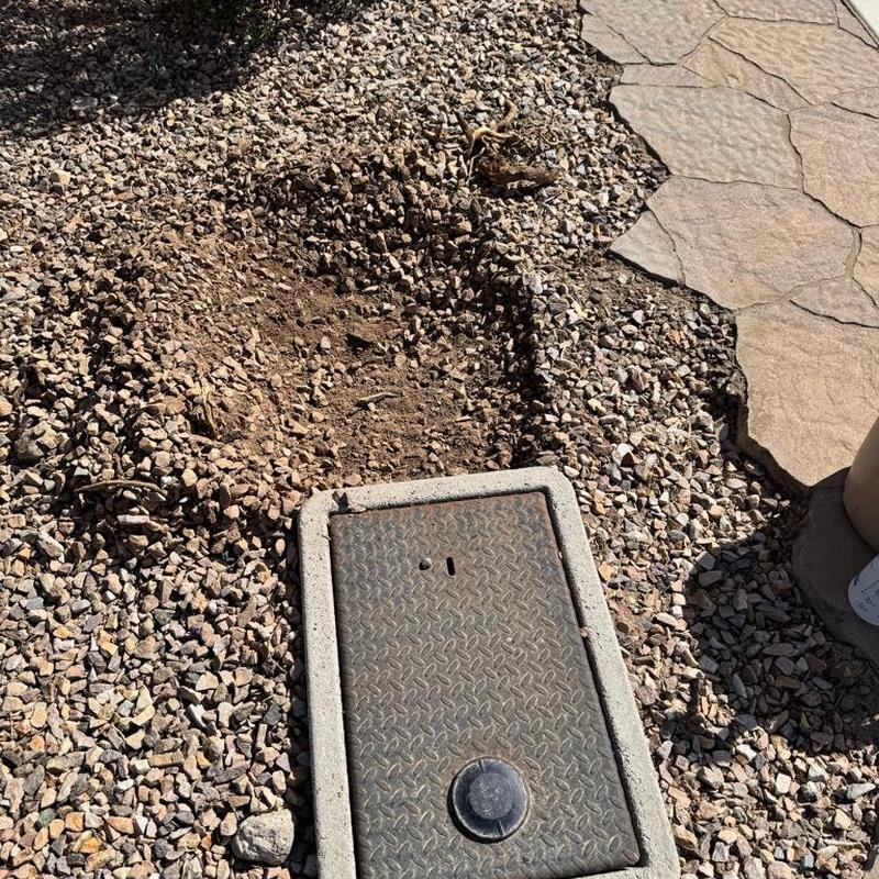 Irrigation valve box installation near stone walkway