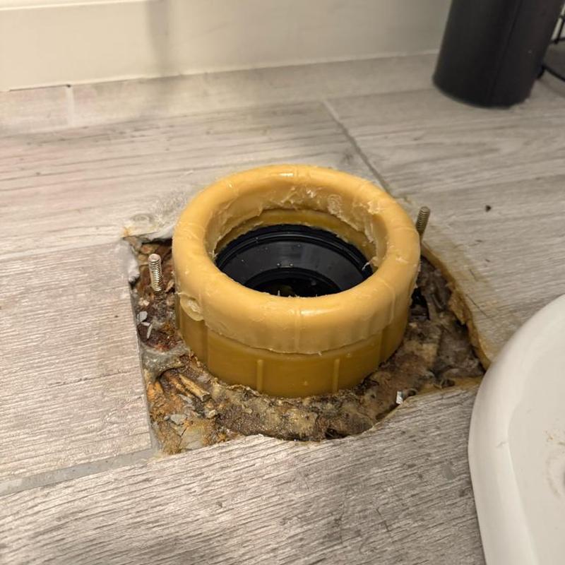 Toilet flange with thick wax ring on tiled floor