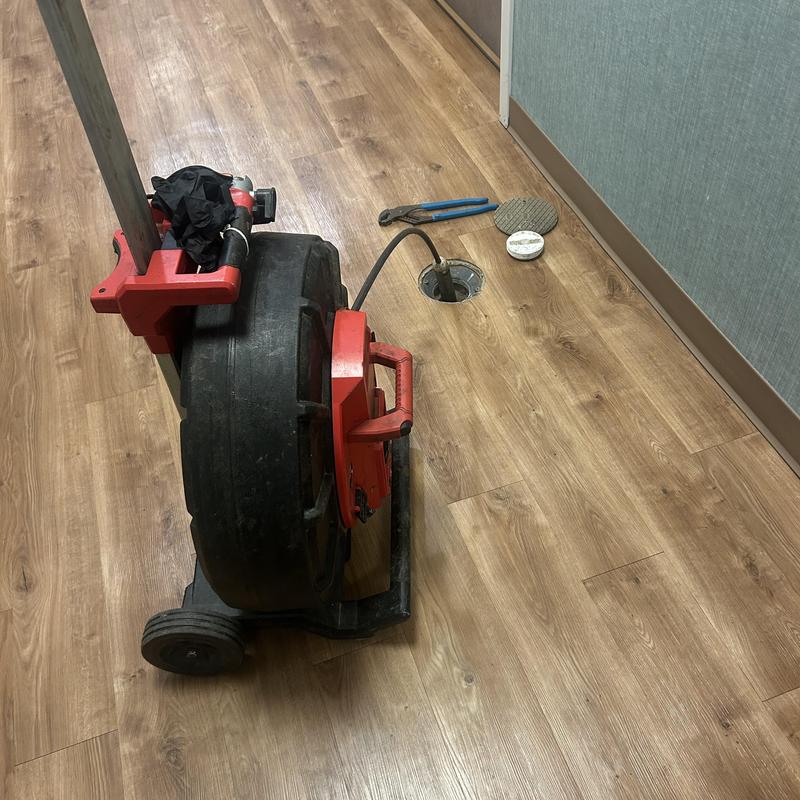 Main line sewer cleaning machine with tools on floor Main line sewer cleaning machine with tools on floor