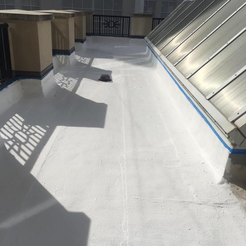 TPO flat roof coating with drain and skylight panels