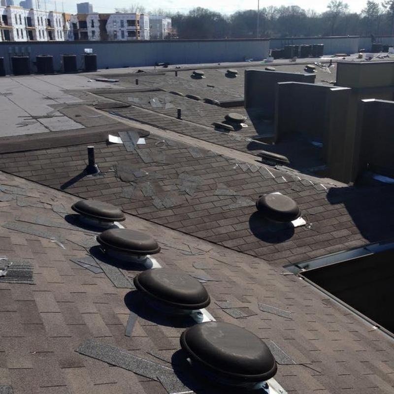 Asphalt shingle roof with broken shingles and vents