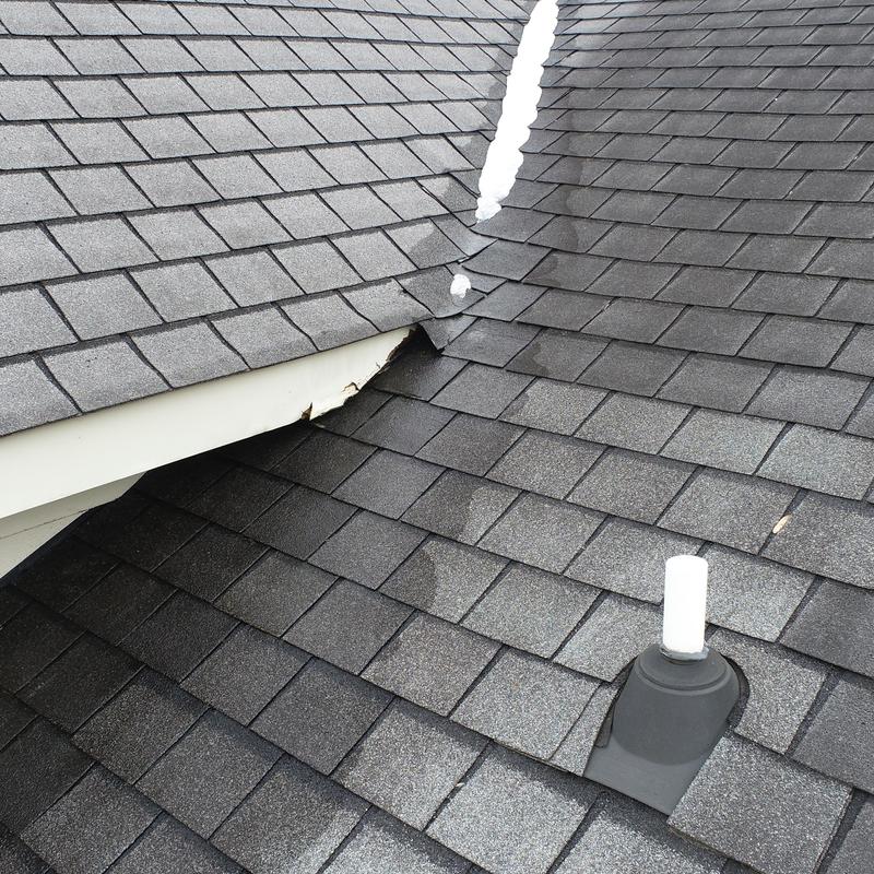 Roof shingles and pipe boot on residential roof junction