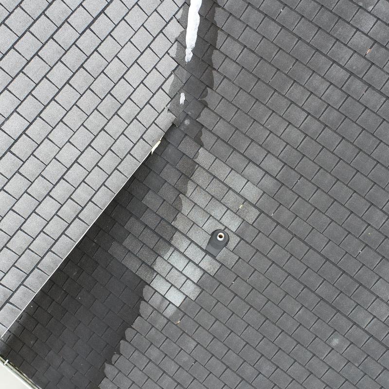 Roof pipe boot on asphalt shingle roof section