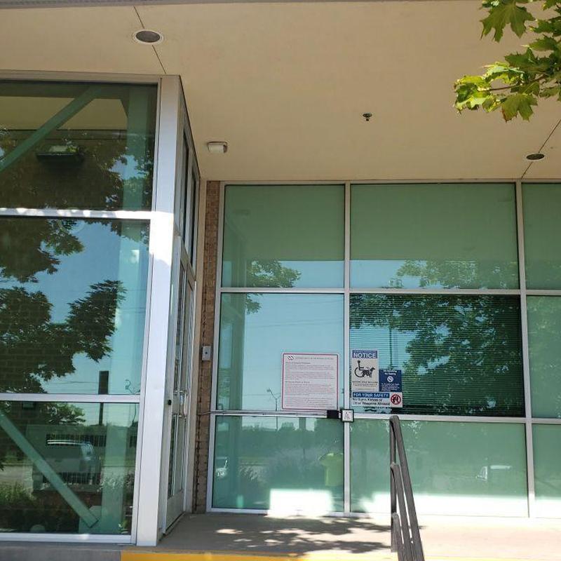 Commercial glass entrance door with safety signs Commercial glass entrance door with safety signs