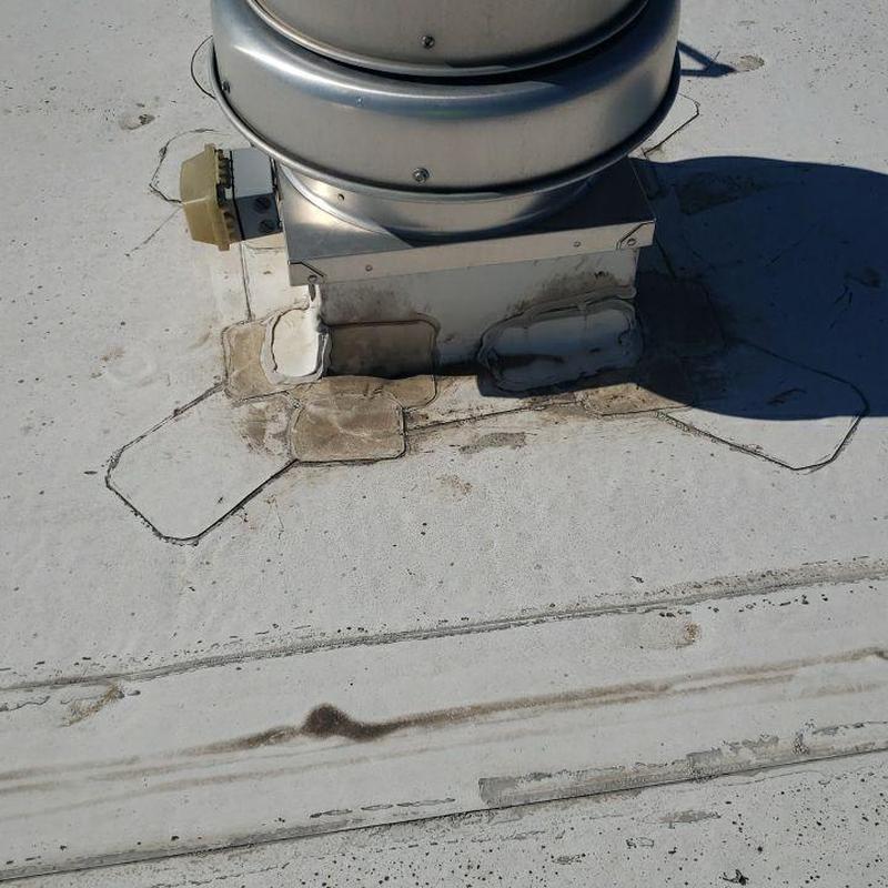 Flat roof ventilation base with patch repairs Flat roof ventilation base with patch repairs