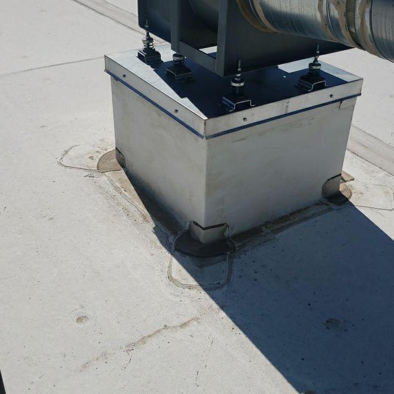 Flat roof HVAC unit curb and flashing repair area Flat roof HVAC unit curb and flashing repair area
