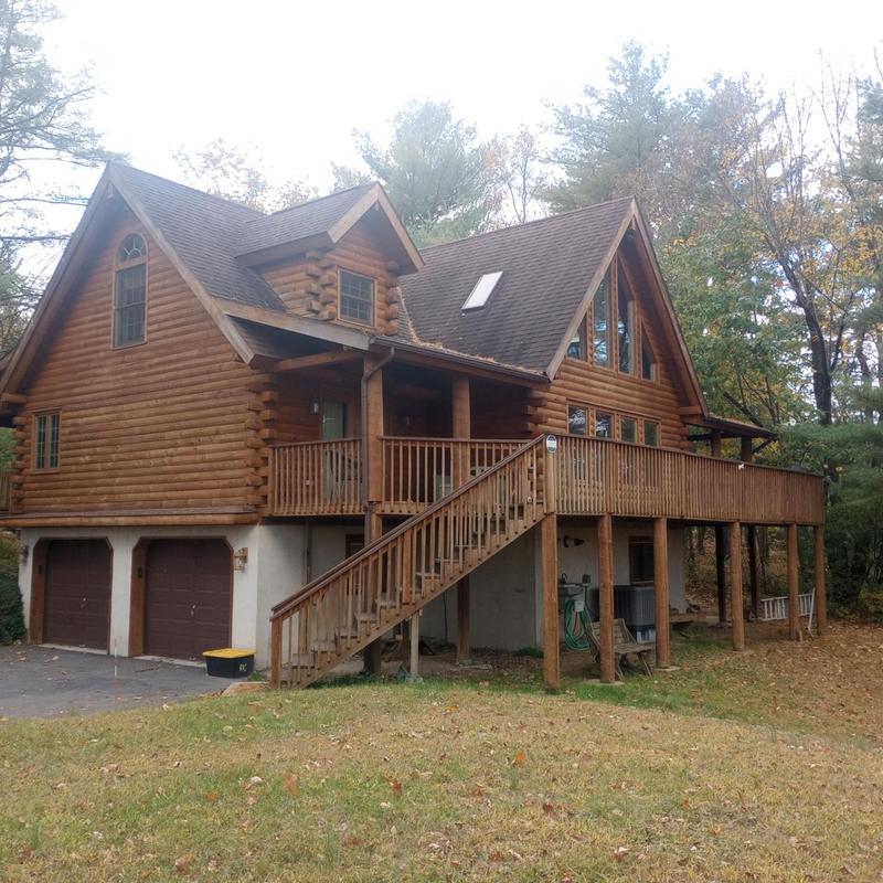 Log cabin roof with skylight and wooden deck