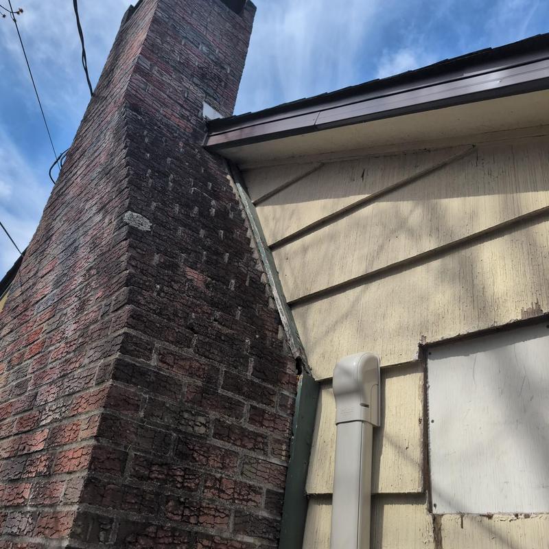 Brick chimney exterior and adjoining roof wall siding Brick chimney exterior and adjoining roof wall siding