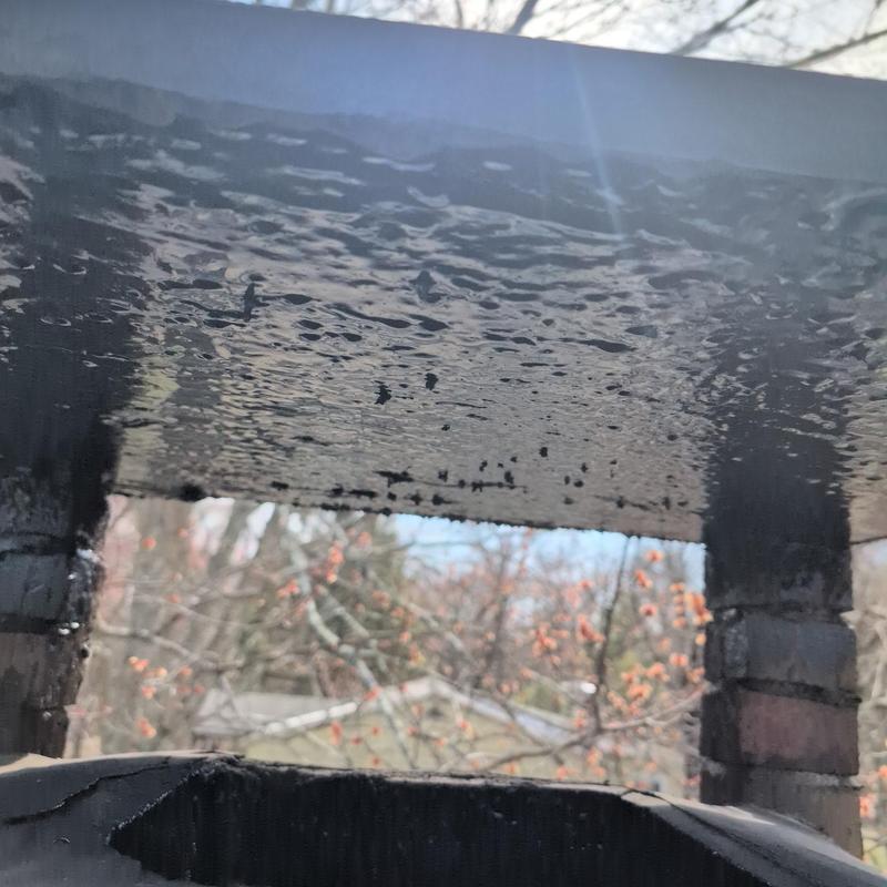 Chimney crown with water damage and black coating Chimney crown with water damage and black coating