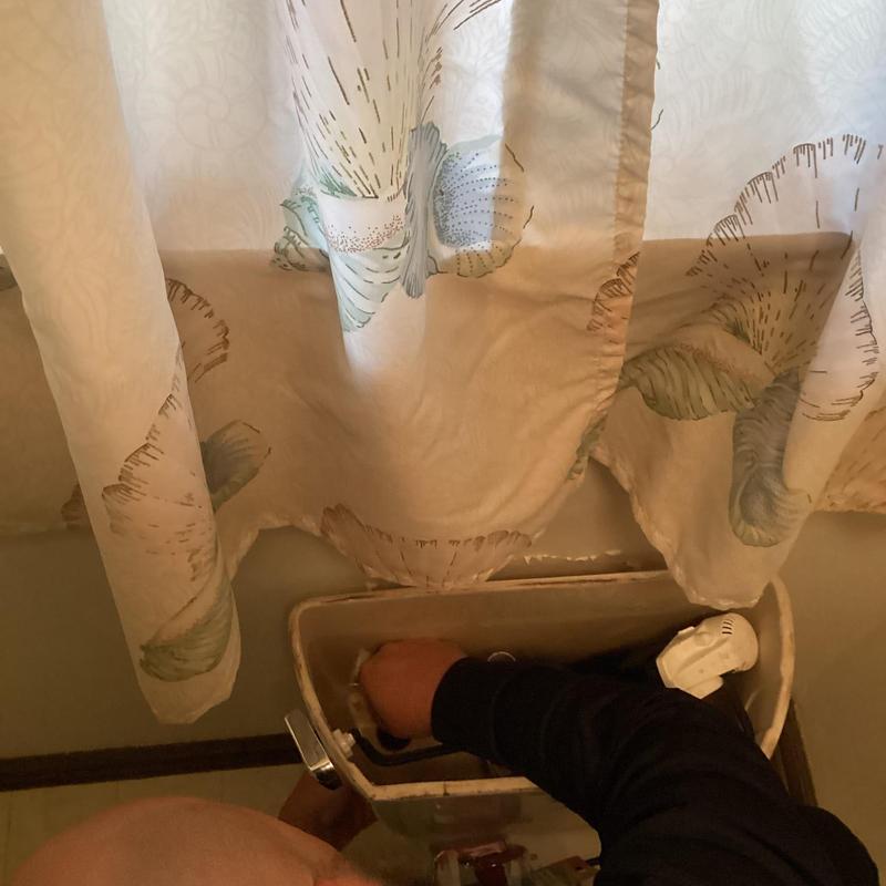 Toilet tank with slow flushing repair in progress