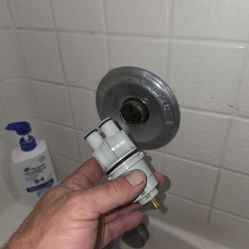 Delta tub shower cartridge held near valve opening
