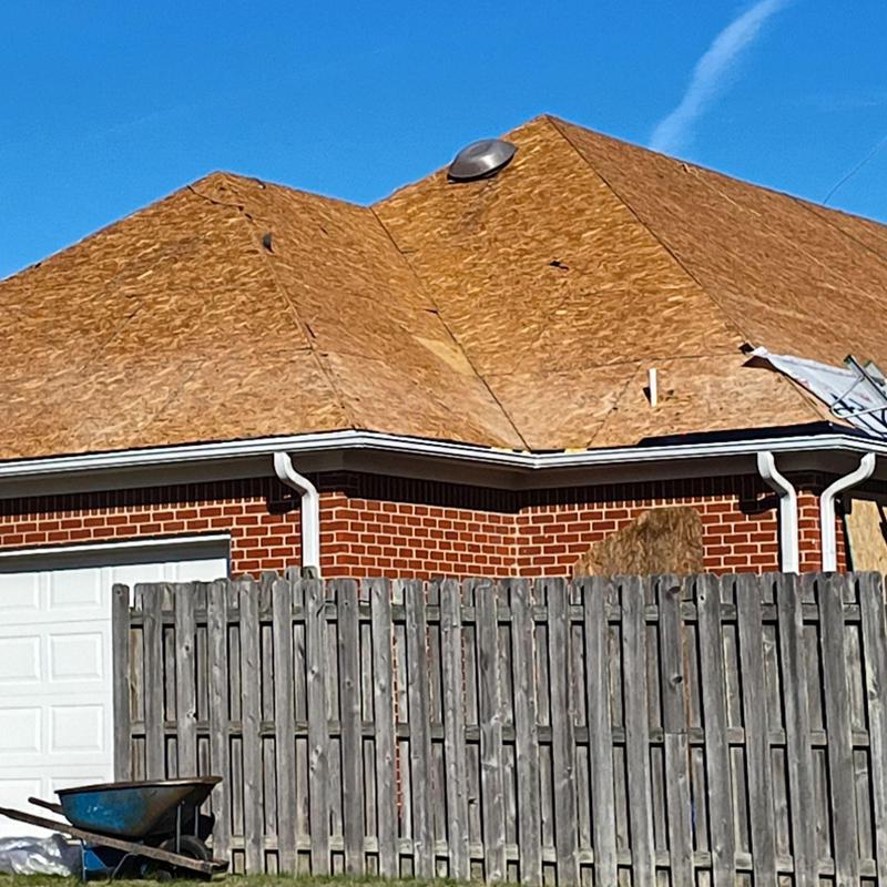 Roof sheathing installation on brick home in Olive Branch