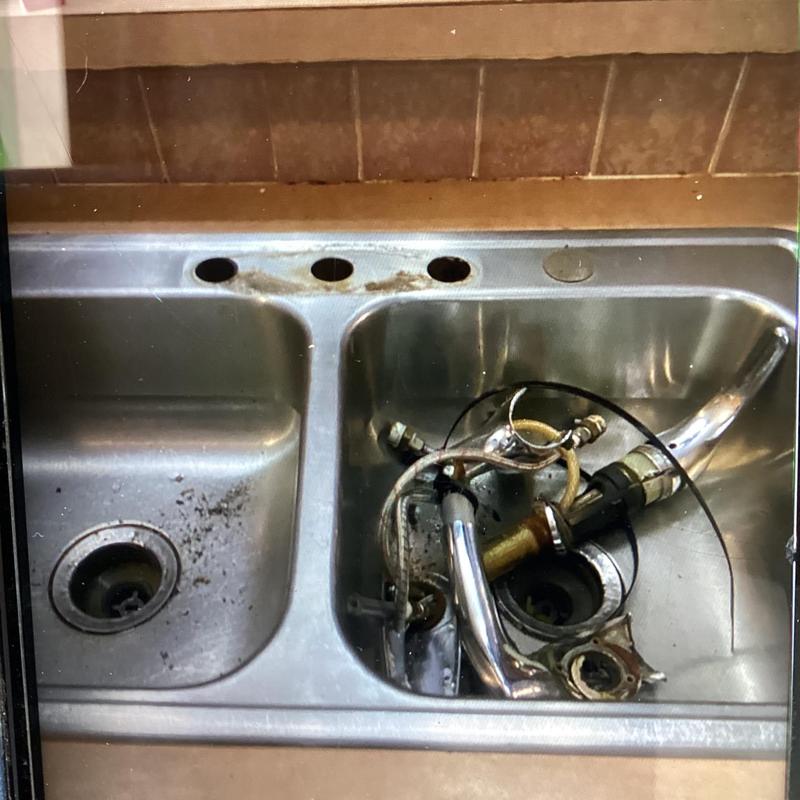 Kitchen faucet parts removed in stainless steel sink