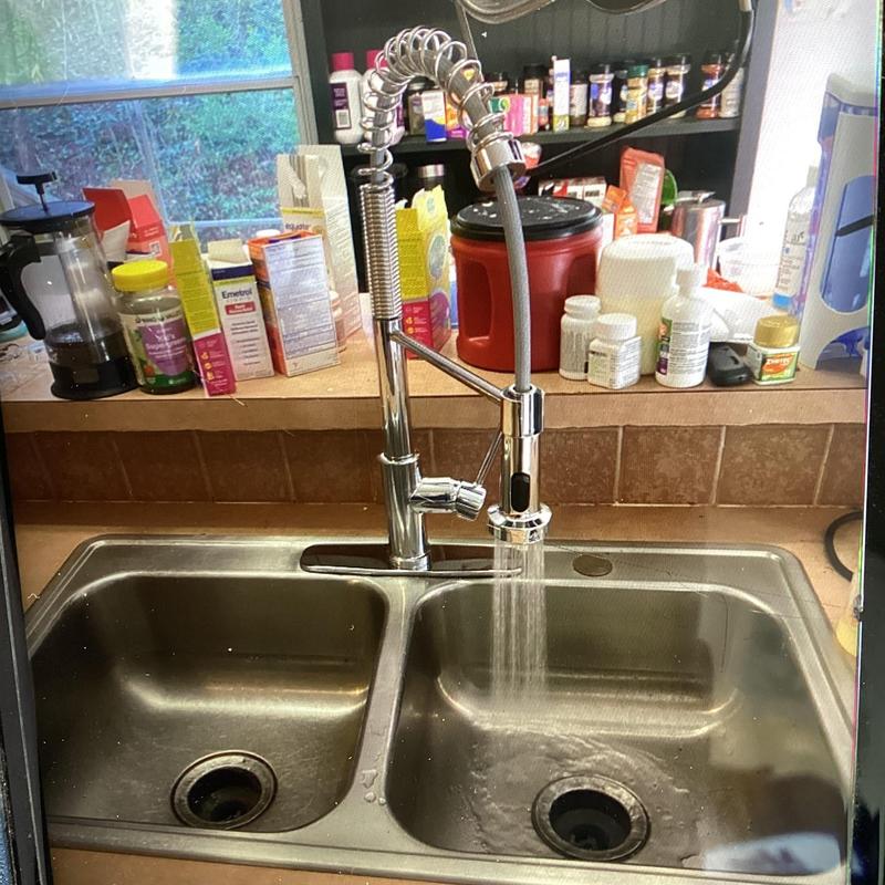 Kitchen faucet with running water over double sink