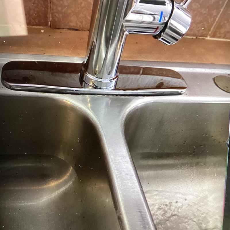 Kitchen faucet and stainless steel sink close-up view