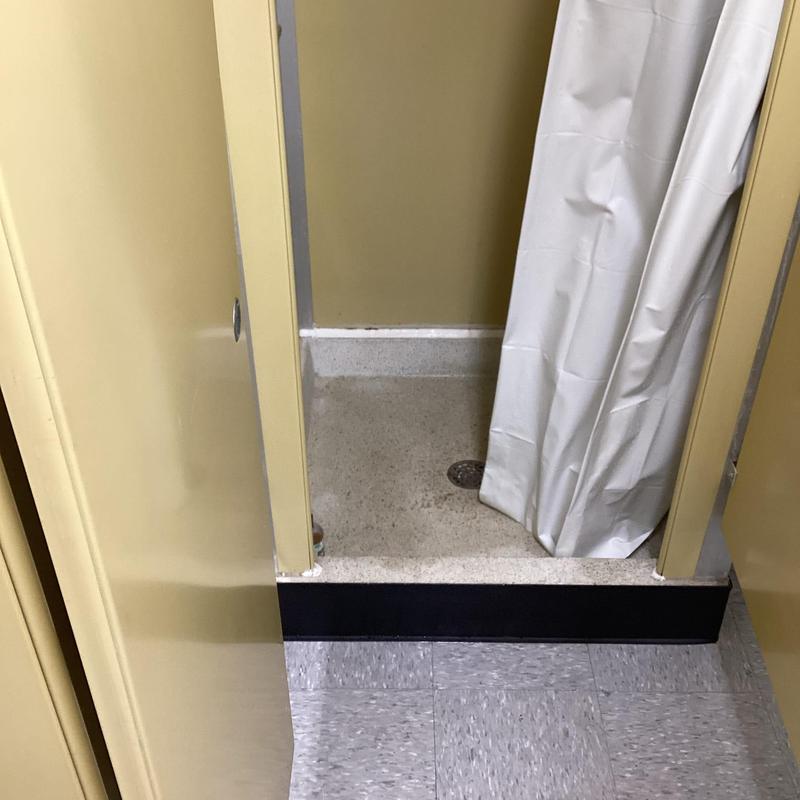 Shower stall floor and curtain in restroom stall