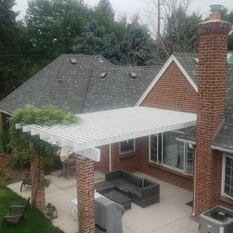 Patio pergola with brick columns and greenery