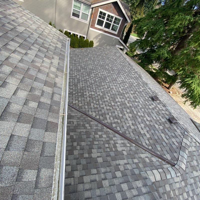 Asphalt shingle roof with cleaned gutters and vents