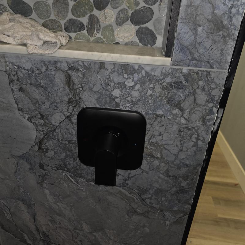 Shower valve trim installation on stone wall