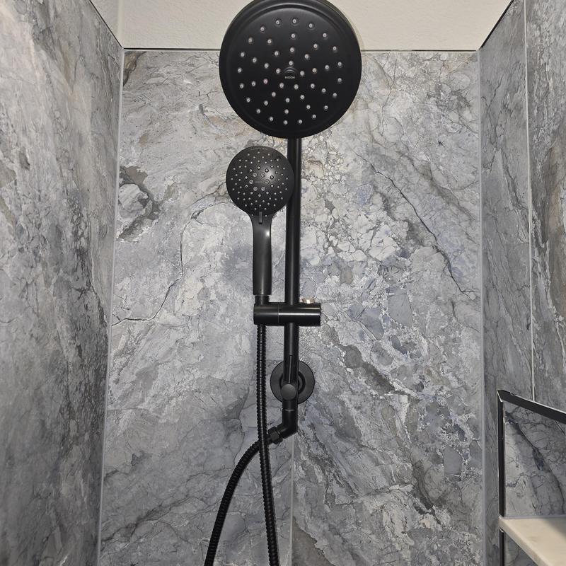 Black dual showerhead with hose on tile wall