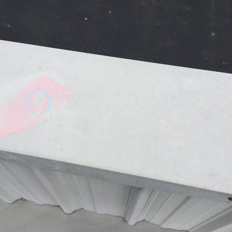 Metal roofing panel with hail damage marking