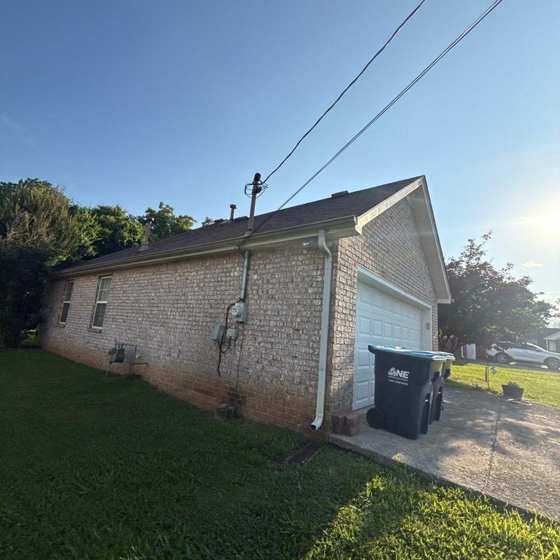 Asphalt shingle roof on brick home with garage