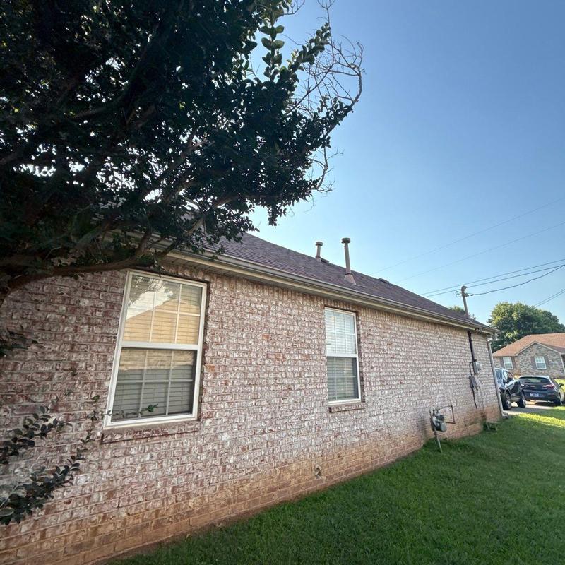 Architectural shingle roof with vents on brick house