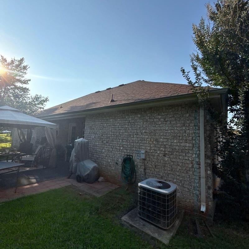 Central air conditioner unit outside brick home