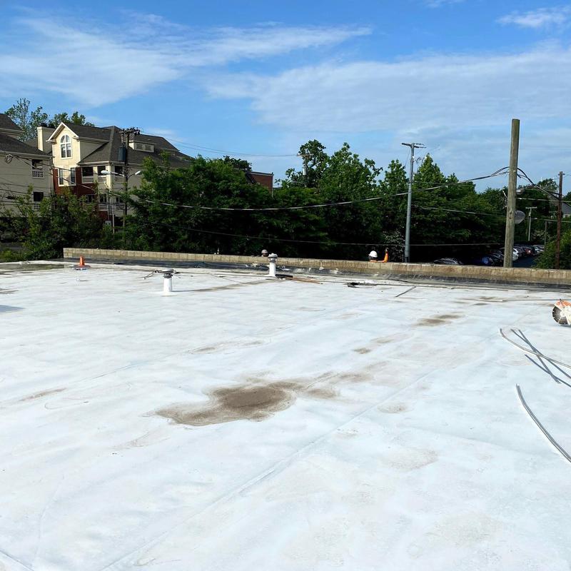 Commercial flat roofing with hail damage spots
