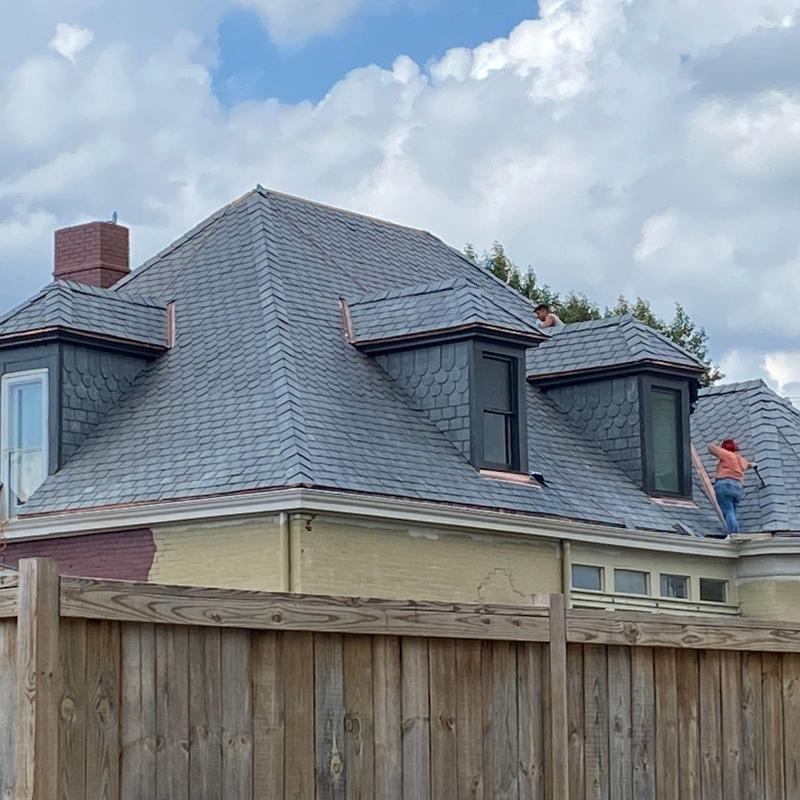 Slate roof inspection with workers on site