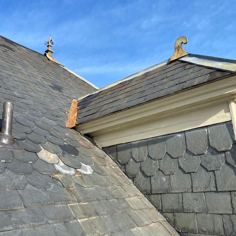 Slate roof shingles with hail and wind damage