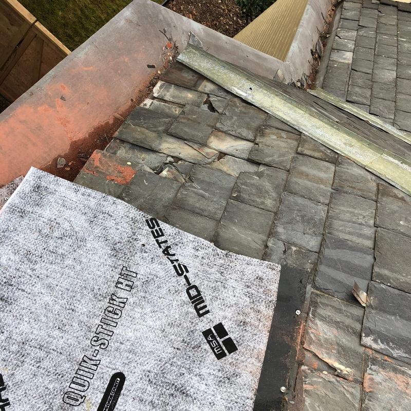 Slate roof shingles with hail damage and flashing removal