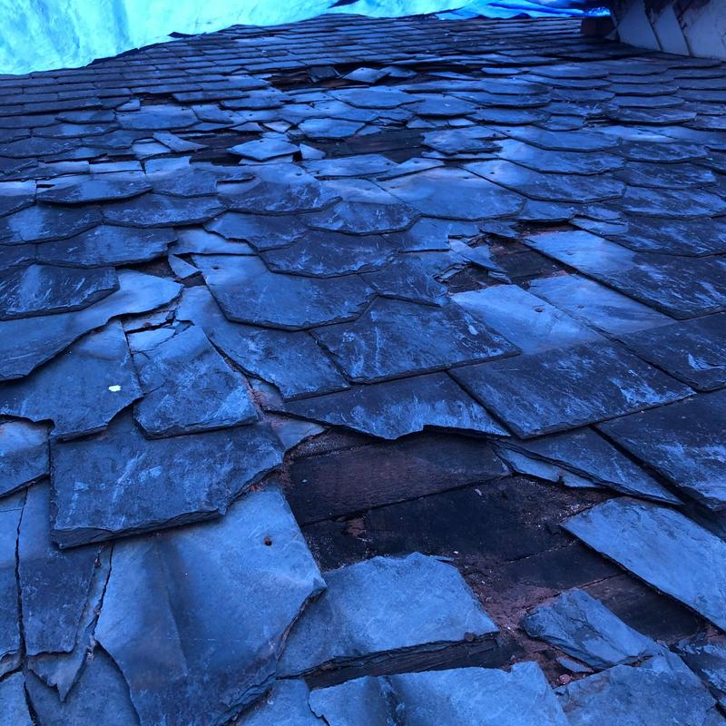 Slate roof with broken and missing shingles